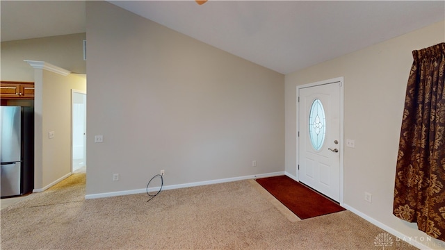 foyer with carpet floors, lofted ceiling, and baseboards