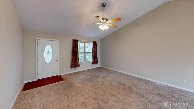 foyer featuring a ceiling fan, lofted ceiling, carpet flooring, and baseboards