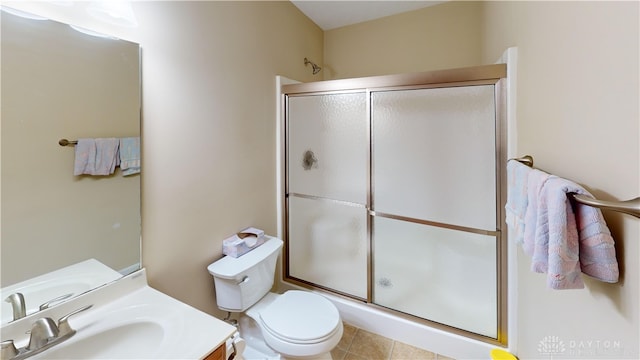 full bath with toilet, tile patterned flooring, vanity, and a shower with shower door