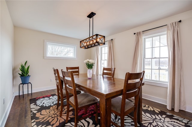 dining area with baseboards and wood finished floors