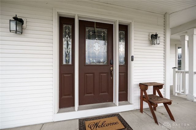 view of exterior entry with a porch