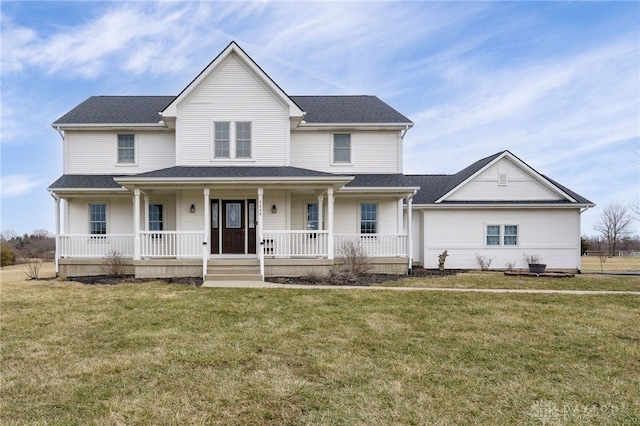 view of front of property with covered porch, a shingled roof, and a front yard