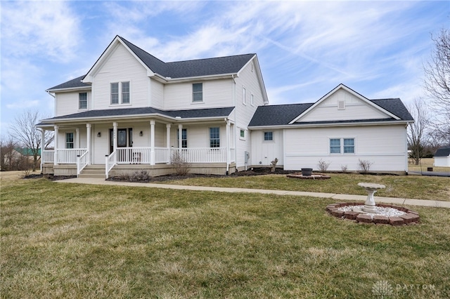 view of front of property featuring covered porch, roof with shingles, and a front yard