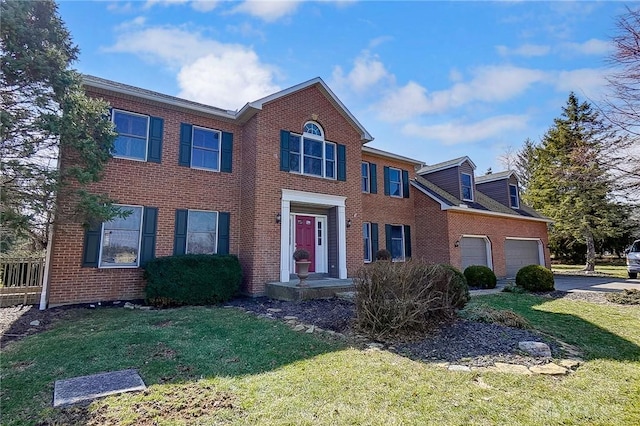 colonial home featuring a garage, brick siding, and a front lawn