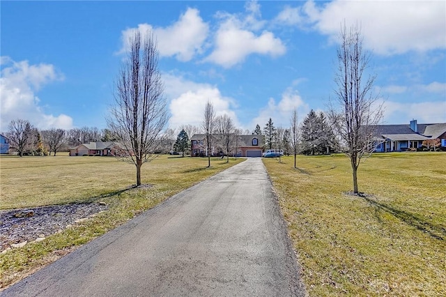 view of road featuring a residential view and aphalt driveway