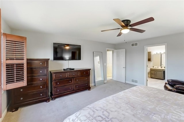 bedroom with light carpet, ensuite bath, visible vents, and ceiling fan