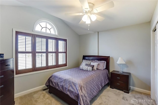 bedroom featuring lofted ceiling, light colored carpet, ceiling fan, and baseboards