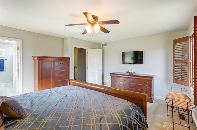 carpeted bedroom featuring a ceiling fan, visible vents, and baseboards