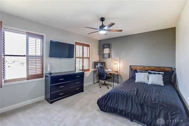 bedroom featuring light carpet, ceiling fan, and baseboards