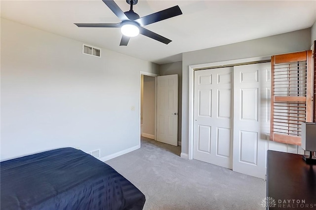 bedroom with baseboards, a closet, visible vents, and carpet flooring