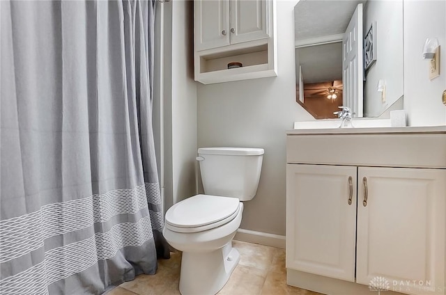 full bathroom with tile patterned flooring, vanity, toilet, and baseboards