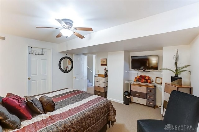 bedroom featuring a ceiling fan, light colored carpet, and visible vents