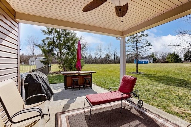 view of patio with a ceiling fan and an outdoor structure