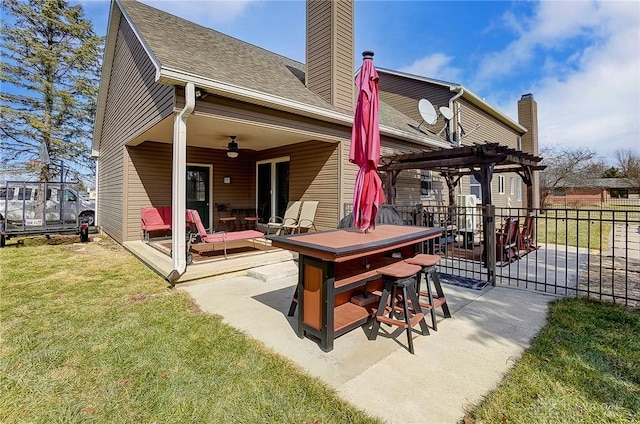 back of house with outdoor dining area, fence, a ceiling fan, a lawn, and a pergola