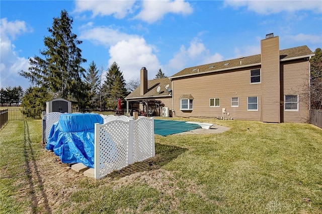 view of pool featuring a fenced backyard, a storage unit, a fenced in pool, and an outdoor structure