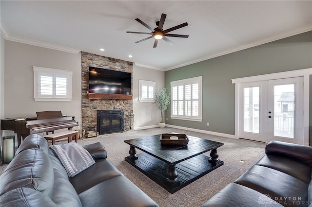 living room with french doors, ornamental molding, carpet flooring, a stone fireplace, and baseboards