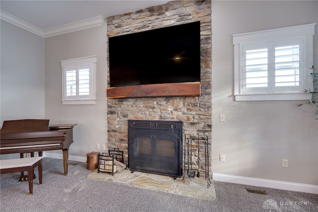 carpeted living area with baseboards, visible vents, and crown molding