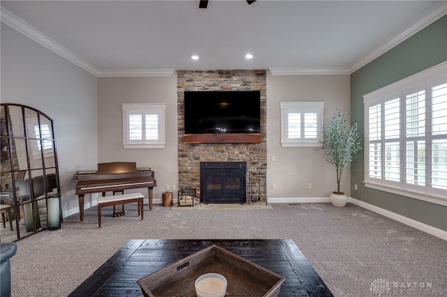 carpeted living room featuring baseboards, recessed lighting, a fireplace, and crown molding