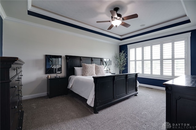 bedroom with carpet, a tray ceiling, and crown molding