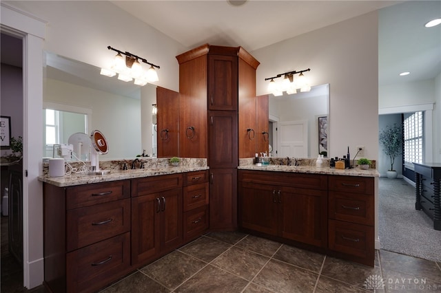 full bathroom featuring a sink and two vanities