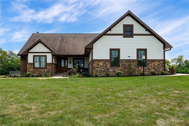 view of front of house with stone siding and a front yard