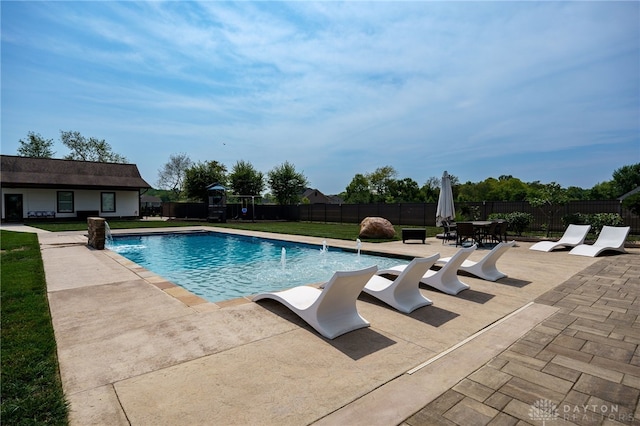 view of swimming pool with a yard, a fenced backyard, a fenced in pool, and a patio