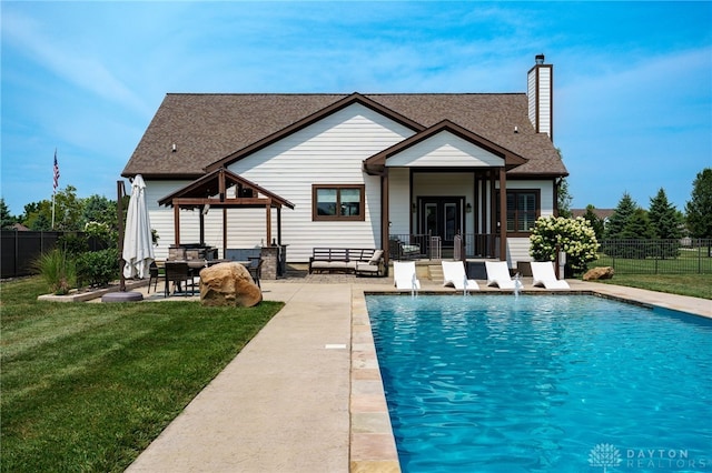 back of house featuring fence, a patio, a gazebo, and a lawn