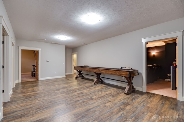 playroom featuring dark wood-style flooring, visible vents, and a textured ceiling