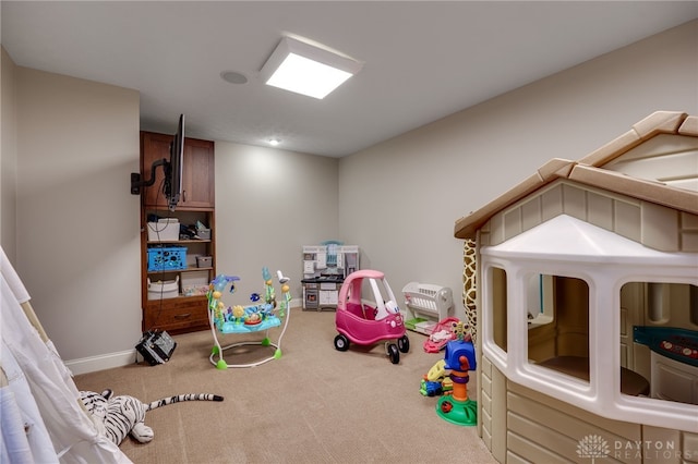 recreation room featuring carpet and baseboards