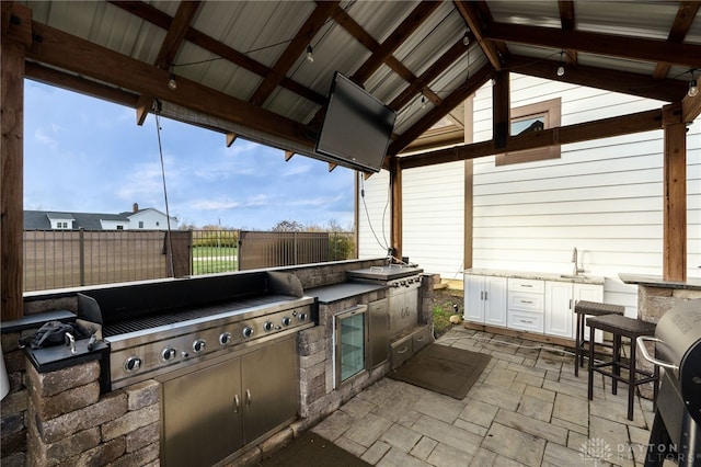 view of patio / terrace with a gazebo, area for grilling, and fence