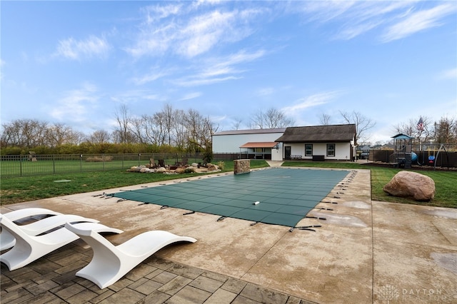 view of swimming pool featuring a yard, a fenced in pool, playground community, and a patio