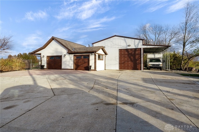 view of property exterior with an outbuilding and driveway