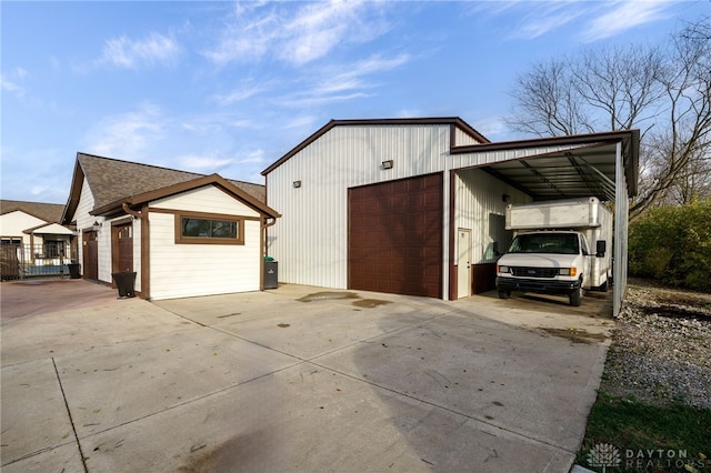 view of property exterior with a garage and an outbuilding