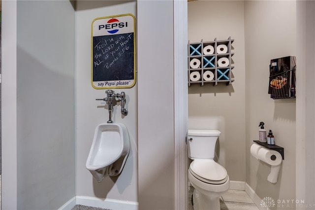 bathroom featuring toilet and baseboards