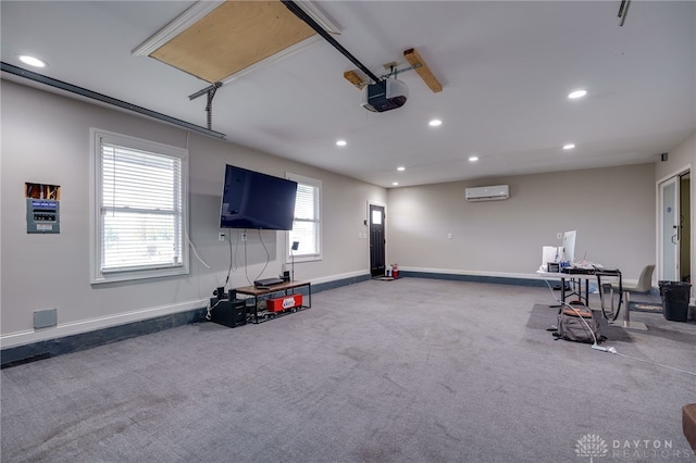 interior space featuring baseboards, a garage door opener, a wall mounted AC, and recessed lighting