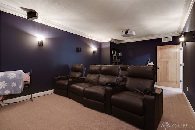 cinema room with ornamental molding, carpet, visible vents, and baseboards