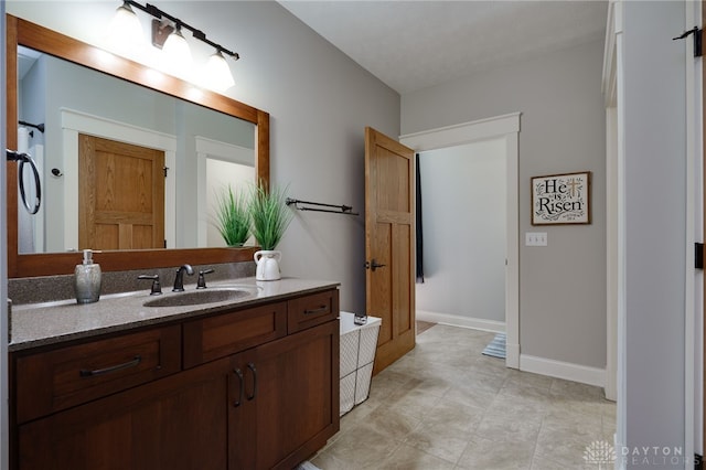 bathroom with vanity and baseboards