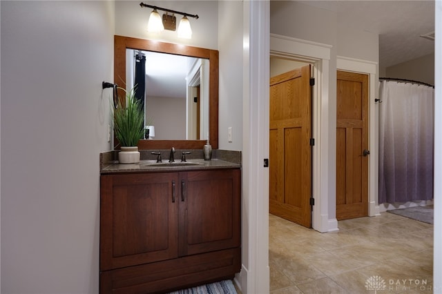 full bath featuring tile patterned flooring, vanity, and a shower with curtain