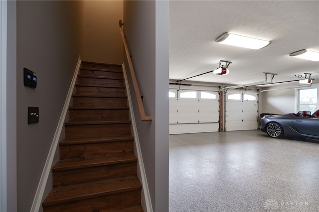 stairs featuring a textured ceiling and speckled floor