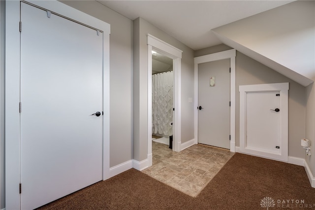 interior space with carpet floors and baseboards