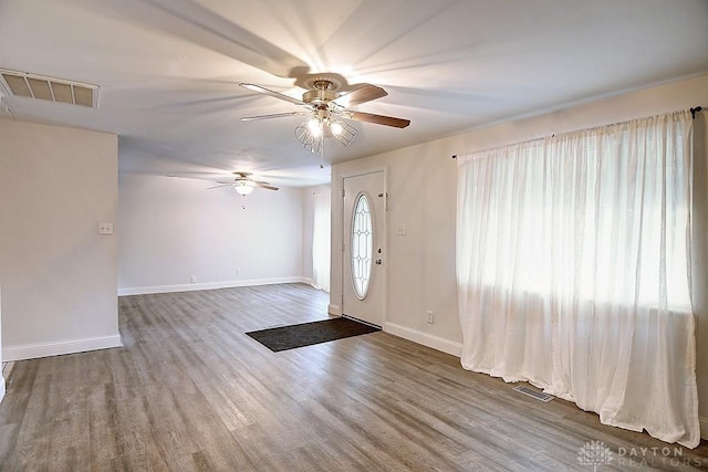 entrance foyer with wood finished floors, visible vents, and baseboards