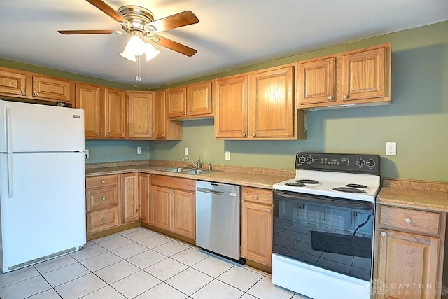 kitchen featuring freestanding refrigerator, light countertops, stainless steel dishwasher, a sink, and range with electric stovetop