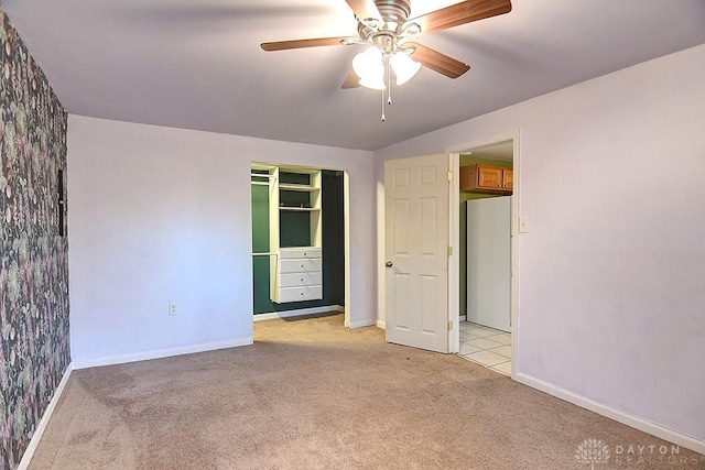 unfurnished room featuring light carpet, ceiling fan, and baseboards