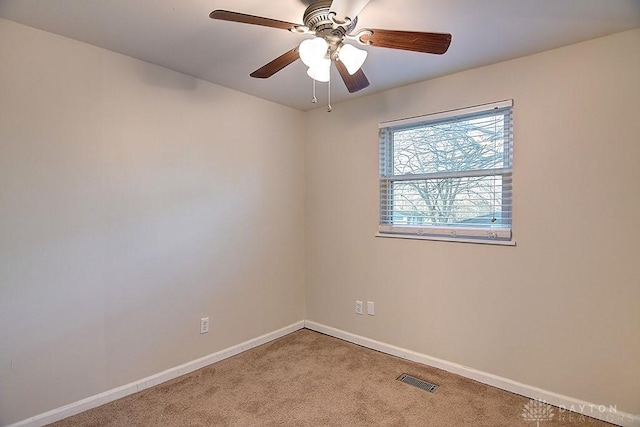 spare room with baseboards, visible vents, ceiling fan, and carpet flooring