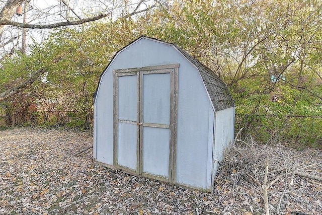 view of shed featuring fence