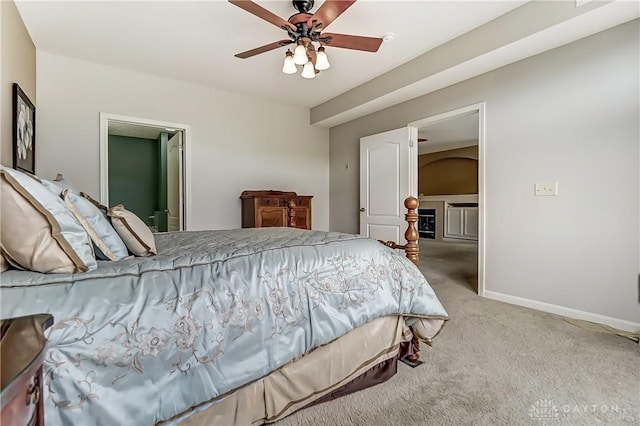 bedroom with a ceiling fan, carpet, and baseboards