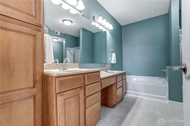 bathroom featuring a bath, a stall shower, double vanity, and a sink