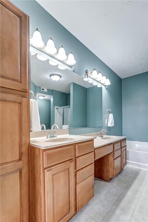 full bath with double vanity, a sink, and visible vents