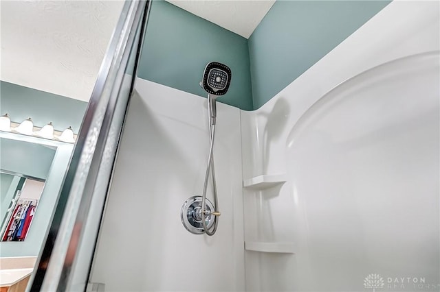 interior details with a shower and vanity