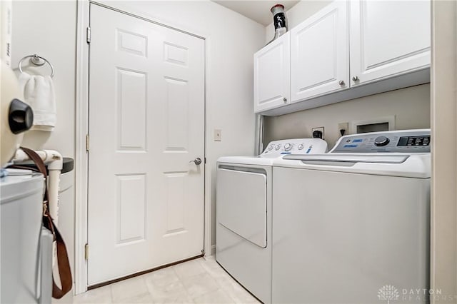 laundry area featuring washing machine and dryer and cabinet space